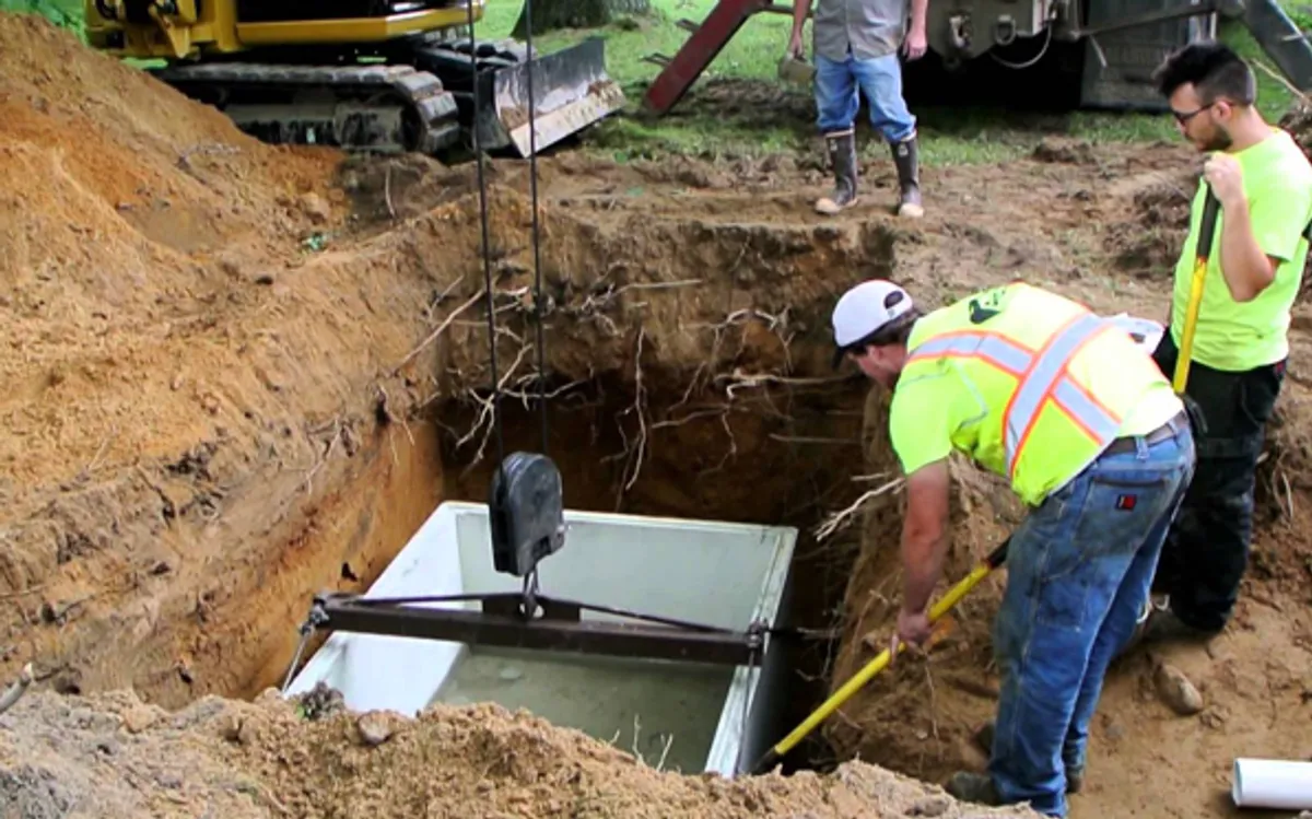 Heavy excavator preparing a residential site for foundation protection and drainage system installation in Houston, TX